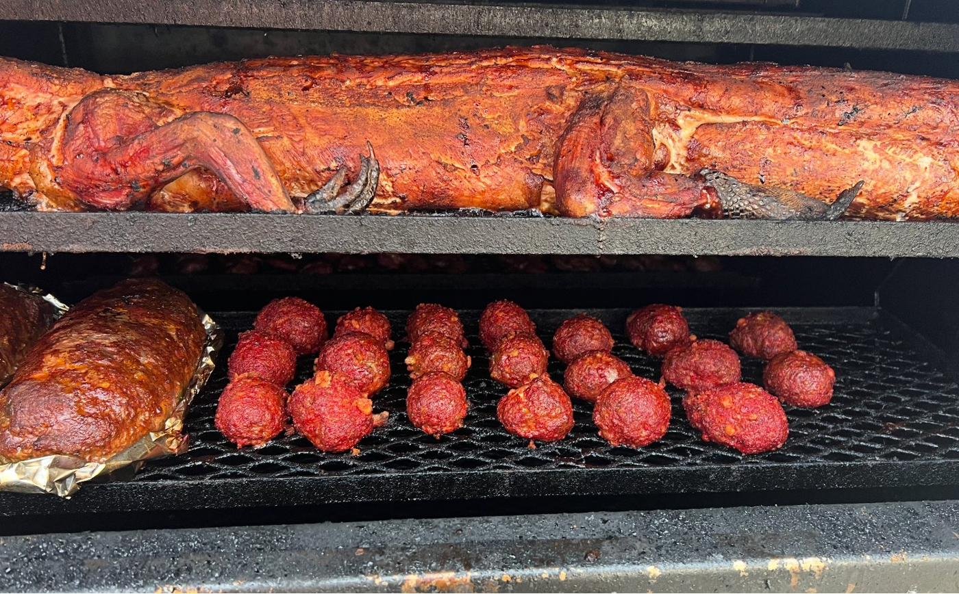 Whole hog and smoked meatballs on the pit